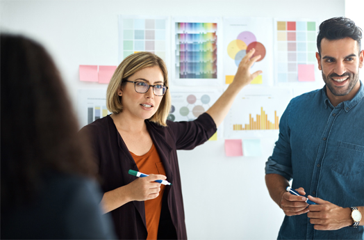 Lady with glasses pointing to chart