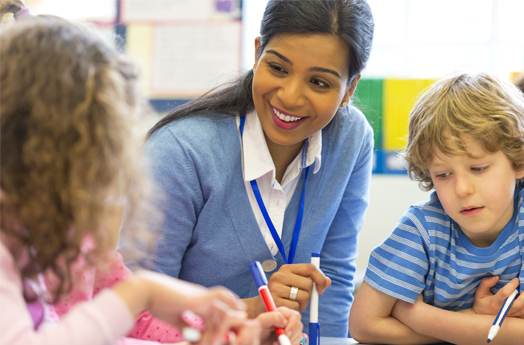 Lady wearing blue jumper with 2 children