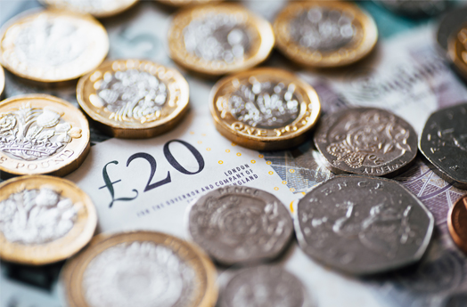 £20 note with coins on top