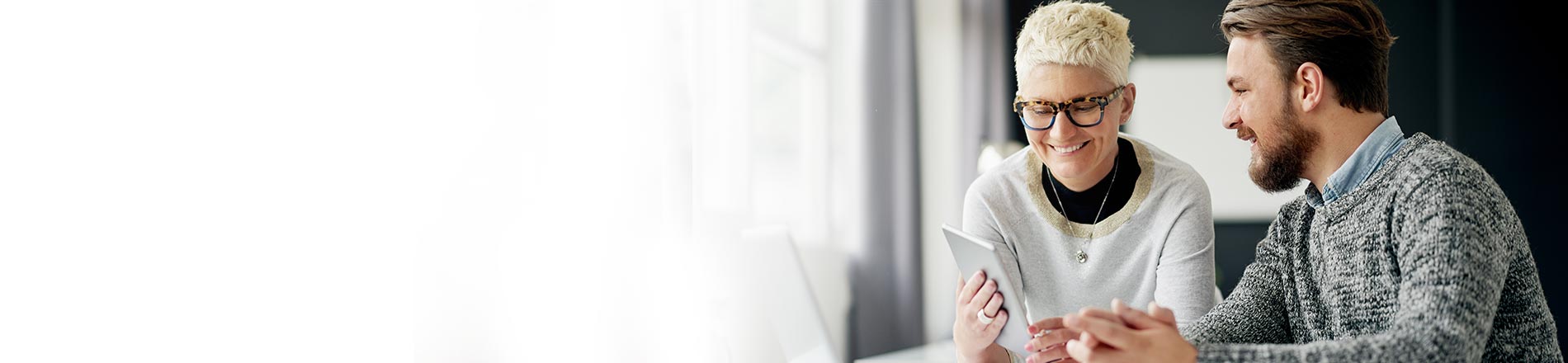 Man and lady looking at mobile device