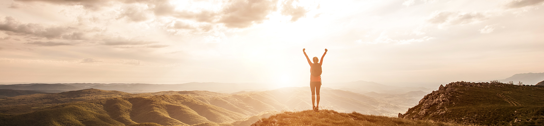 Woman on top of mountain